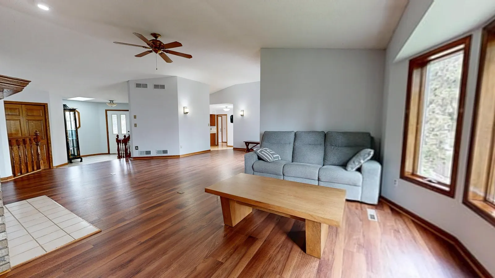 Hardwood Flooring Living room with warm-toned wood-look plank flooring