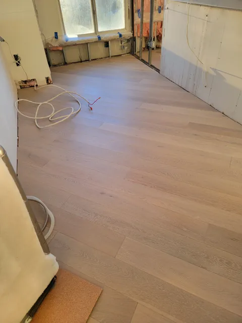 New engineered hardwood running the length of the kitchen toward the windows, Toronto condo
